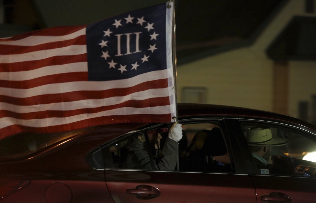 People carry flags in a convoy of vehicles during the ‘Stand Your Ground’ rally opposed to the shooting death of Robert ‘LaVoy’ Finicum organised by the Pacific Patriots Network in Burns Oregon. – Reuters pic