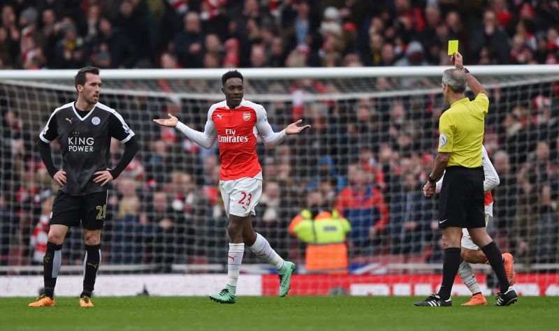 Arsenal's Danny Welbeck is shown a yellow card by referee Martin Atkinson after he celebrates scoring the second goal. Third-placed Arsenal's victory was secured by Danny Welbeck in the dying seconds against Leicester. – Reuters pic