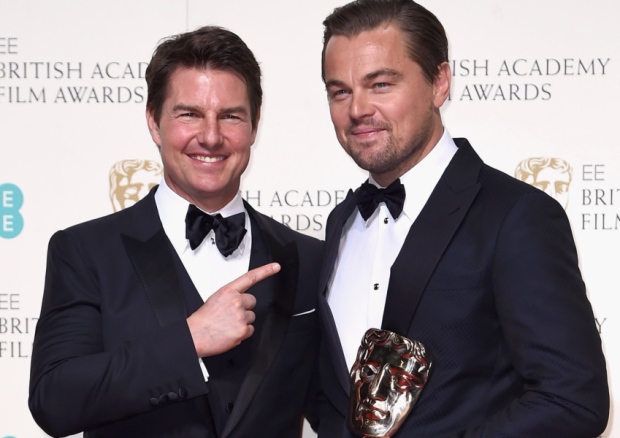 Leonardo Di Caprio holding his BAFTA for Best Award with actor Tom Cruise