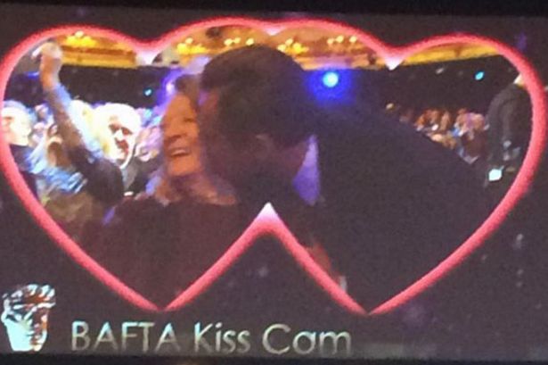 Leonardo steals a kiss from Maggie Smith