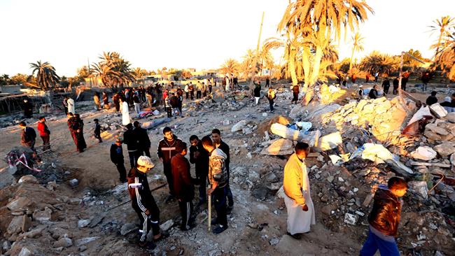 Libyans gather next to debris at the site of a suspected Daesh training camp targeted in a US airstrike near Sabratha Feb. 19 2016