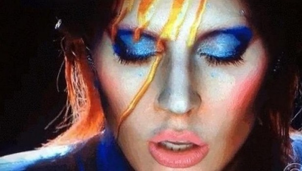 Light fantastic... Lady Gaga began her Bowie tribute with futuristic projections on her face