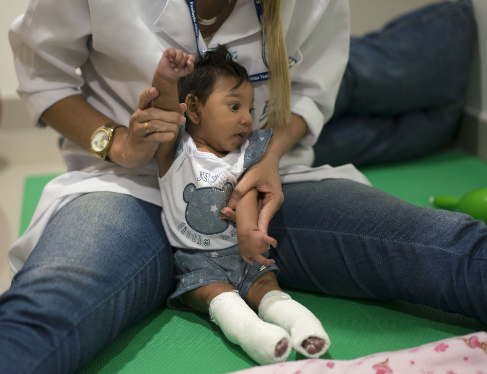 A therapist works with a microcephaly patient at a treatment center in Recife Brazil on Thursday. Brazilian authorities say they have detected a spike in the cases of small heads in newborns but a link between Zika virus and microcephaly is as yet unpr