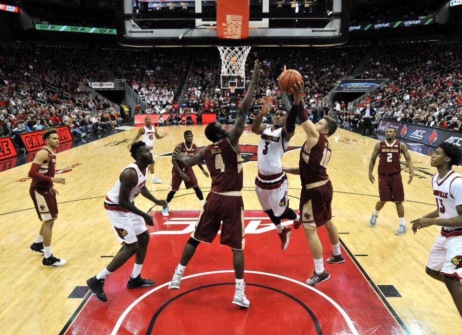 Louisville's Trey Lewis attempts a layup between the defense of Boston College's Idy Diallo and Ervins Meznieks during the second half of an NCAA college basketball game Saturday Feb. 6 2016 in Louisville Ky. Louisville won 79-47