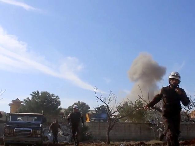 Syrian Civil Defence rescuers running from the site of an explosion near a hospital run by MSF in Maaret al-Numan Idlib Syria on Monday