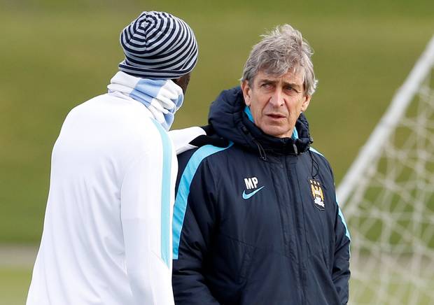 Manchester City boss Manuel Pellegrini chats with Yaya Toure in training ahead of tomorrow’s League Cup final