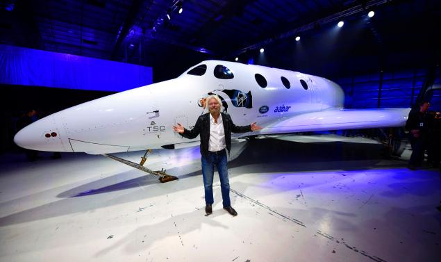 Sir Richard Branson poses in front of Virgin Galactic's SpaceShipTwo space tourism rocket