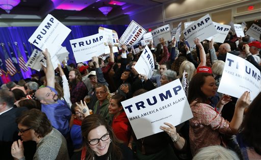 Supporters for Republican presidential candidate Donald Trump hold signs during a South Carolina Republican primary night event Saturday Feb. 20 2016 in Spartanburg S.C