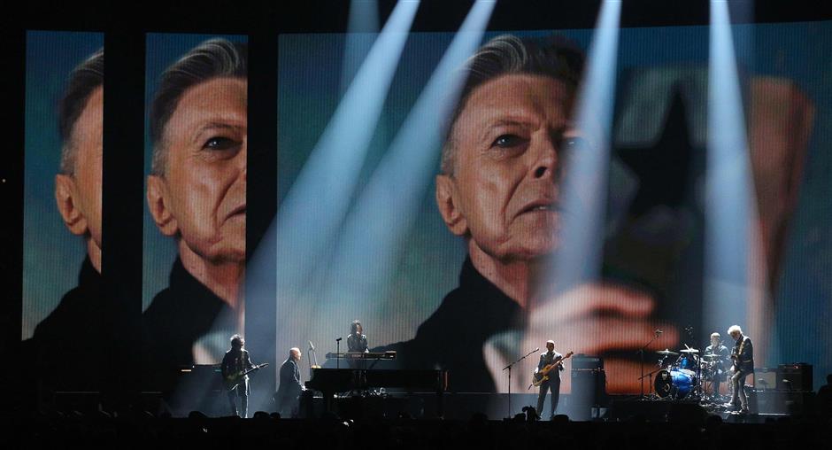 Members of David Bowie’s band perform a tribute to the artist at the Brit Awards