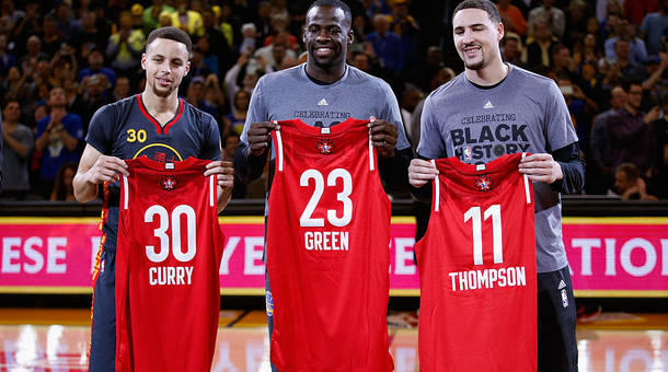 Stephen Curry #30 Draymond Green #23 and Klay Thompson #11 of the Golden State Warriors hold up their respective All Star jerseys before their game against the Houston Rockets at ORACLE Arena