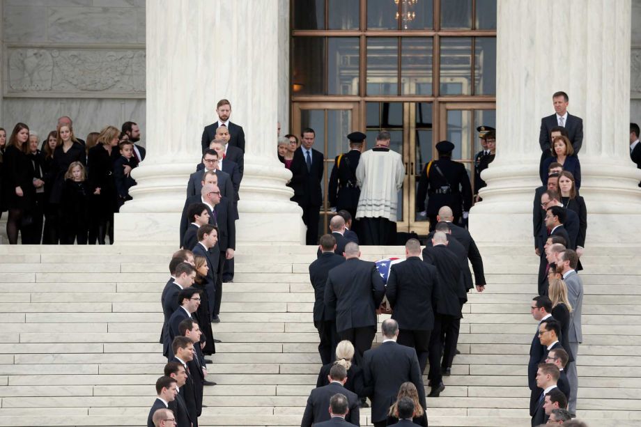 The body of Justice Antonin Scalia arrives at the Supreme Court in Washington Friday Feb. 19 2016. Thousands of mourners will pay their respects Friday for Justice Antonin Scalia as his casket rests in the Great Hall of the Supreme Court where he spen