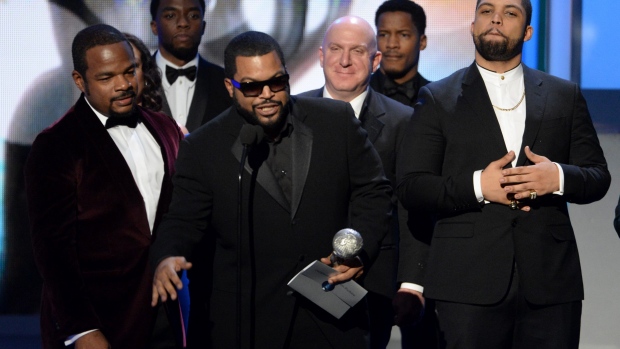 F. Gary Gray left Ice Cube center O'Shea Jackson Jr. right and the cast of Straight Outta Compton accept award for Outstanding Motion