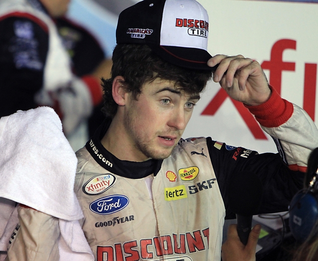 Ryan Blaney adjusts his cap after winning the NASCAR Xfinity series auto race at Kentucky Speedway in Sparta Ky