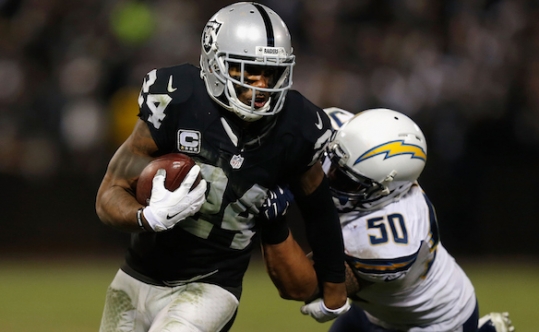 Charles Woodson of the Oakland Raiders carries the ball against the San Diego Chargers at the