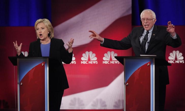 Democratic U.S. presidential candidate and former Secretary of State Hillary Clinton and rival candidate U.S. Senator Bernie Sanders speak simultaneously at the NBC News- You Tube Democratic presidential candidates debate in Charleston South Carolina Jan