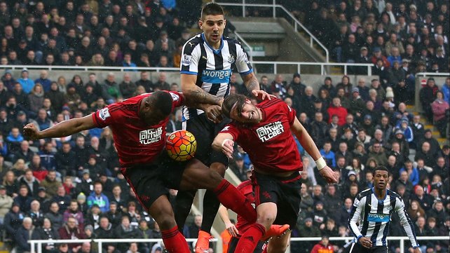 Newcastle's Aleksandar Mitrovic gets between Victor Anichebe and Jonas Olsson