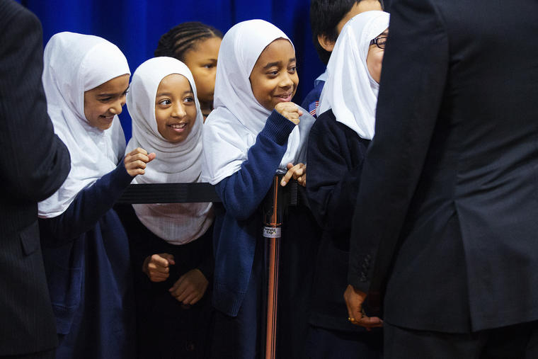 Young girls close their hands in anticipation of'fist-bumping President Barack Obama right after he spoke at the Islamic Society of Baltimore Feb. 3 2016 in Baltimore Md