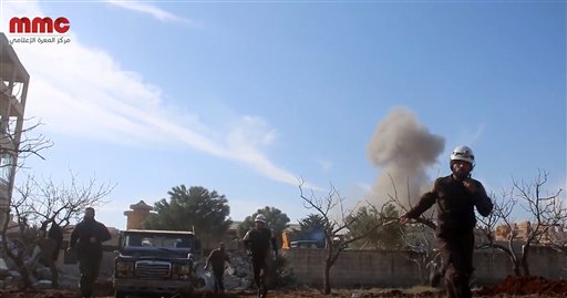 This image taken from video provided by the Syrian activist-based media group Maara Media Center which has-been verified and is consistent with other AP reporting shows Syrian Civil Defense rescuers running from the site of a second explosion near a hos