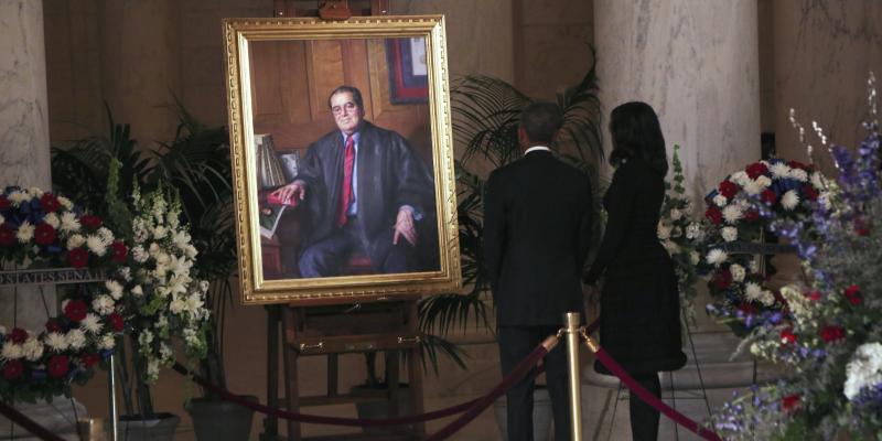 President Obama and first lady Michelle Obama look at a portrait of U.S. Supreme Court Justice Antonin Scalia after paying their respects in the Great Hall of the Supreme Court in Washington D.C