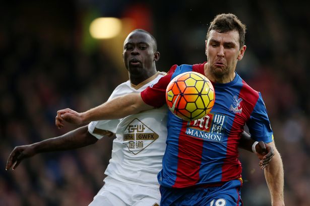 Crystal Palace's James Mc Arthur holds off Swansea City's Mo Barrow