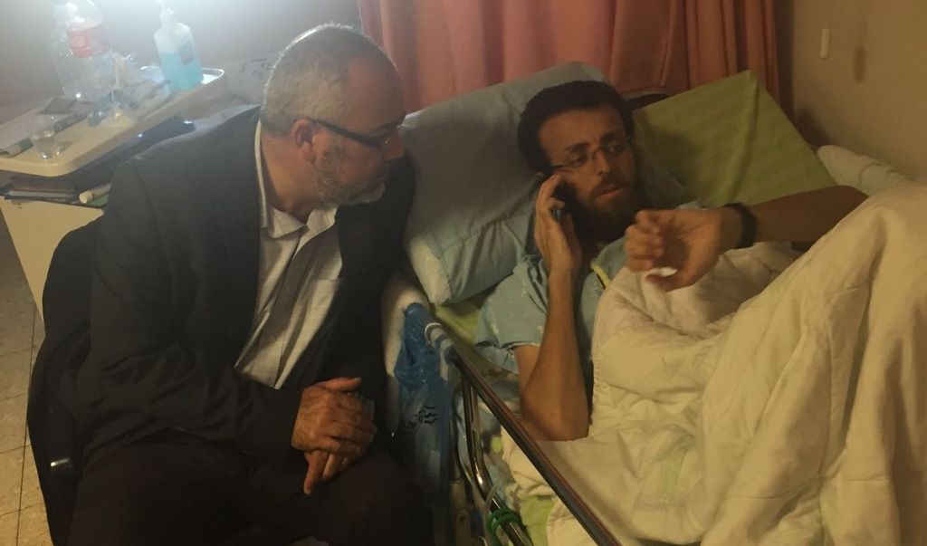 Palestinian hunger striker Mohammed al Qiq with Joint List MK Osama Sa'adi at the Emek Medical Center in Afula