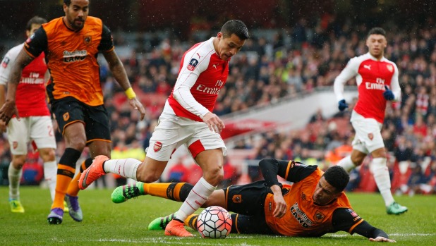 Arsenal's Alexis Sanchez goes past Hull City's Curtis Davies before getting a shot on goal during the FA Cup fifth round clash