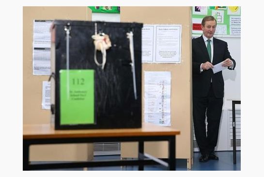 Ireland's Prime Minister Enda Kenny prepares to cast his vote at a polling station at St Anthony's School in Castlebar Ireland Friday Feb. 26 2016. Ireland’s voters were deciding Friday who should lead their economically rebounding nation for the nex