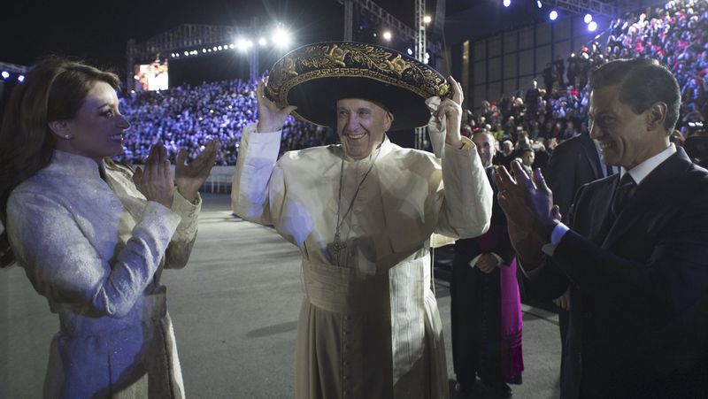 Pope Francis wears a sombrero hat as he meets Mexico's President Enrique Pena Nieto and first lady Angelica Rivera after his arrival in Mexico City. – Reuters pic