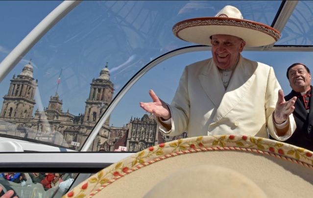 Pope Francis gestures while wearing a Mariachi hat given to him by someone in the crowd on Zocalo Square in Mexico City