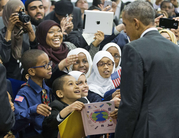 President Obama greets schoolchildren and other guests during his visit to the Islamic Society of Baltimore. He said Muslims are blamed'for the violent acts of the very few. PABLO MARTINEZ MONSIVAIS  AP