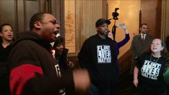 Protesters chant loudly during Gov. Snyder’s budget presentation