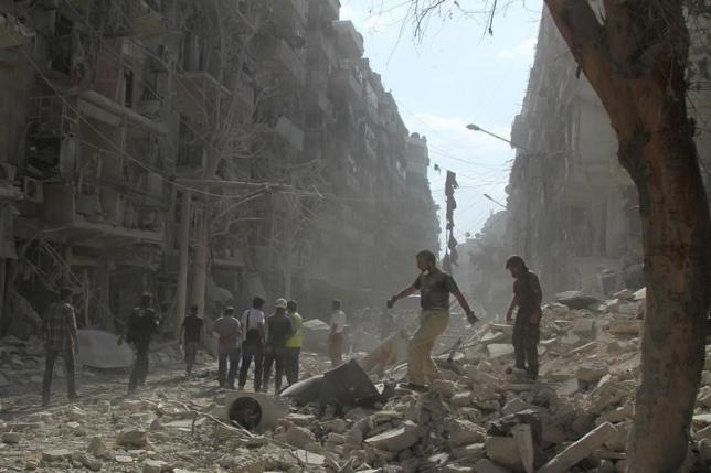 Residents and civil defense members look for survivors at a damaged site after what activists said was a barrel bomb dropped by forces loyal to Syria's President Bashar al Assad in the Al Shaar nighbourhood of Aleppo Syria