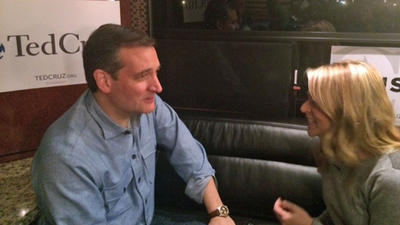 Reporter Julie Fine talks with U.S. Sen. Ted Cruz on his campaign bus in Iowa Jan. 31 2016