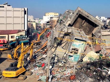 Rescue workers using excavators continue to search the rubble of a collapsed building complex in Tainan Taiwan Tuesday Feb. 9 2016