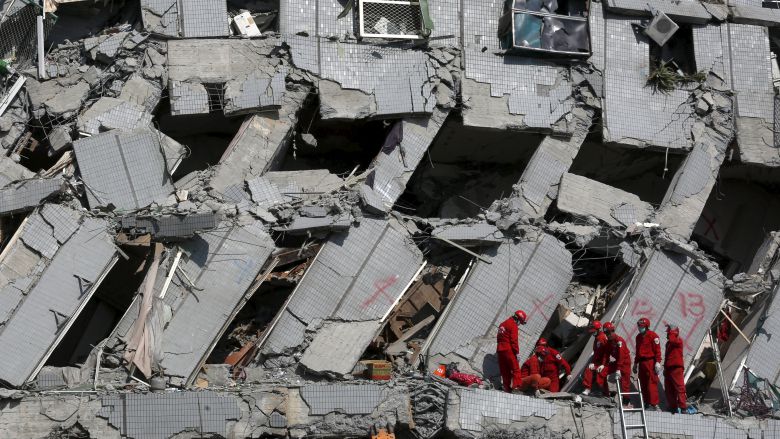 Rescue personnel work at the site where a 17-storey apartment building collapsed after an earthquake hit Tainan on Saturday. Officials believe the death toll could reach 100. REUTERS  Tyrone Siu