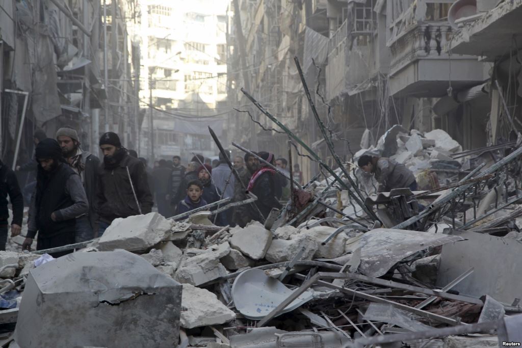 Residents inspect damage after airstrikes by pro Syrian government forces in the rebel held Al Shaar neighborhood of Aleppo Syria Feb. 4 2016