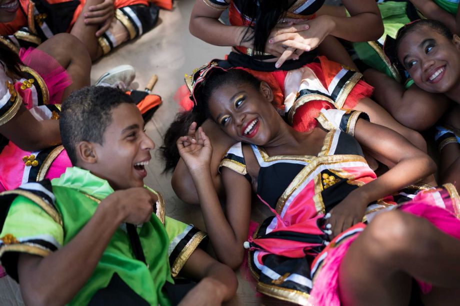 Young revelers joke with each other as they lay on the shade during the'Burial of the Mosquito carnival block parade in Olinda Pernambuco state Brazil Friday Feb. 5 2016. The parade that happens every year during carnival informs residents and tour