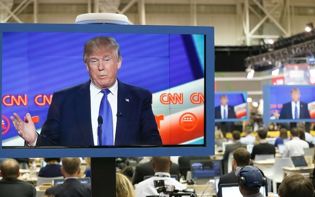 US Republican Presidential Candidate Donald Trump is seen on television in the CNN filing room during the Republican Presidential Debate in Houston Texas