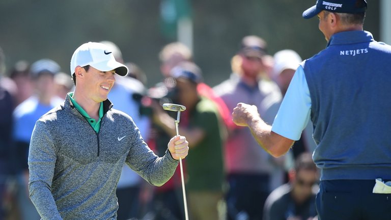 Rory Mc Ilroy celebrates with Matt Kuchar after sinking a monster putt for birdie at the third