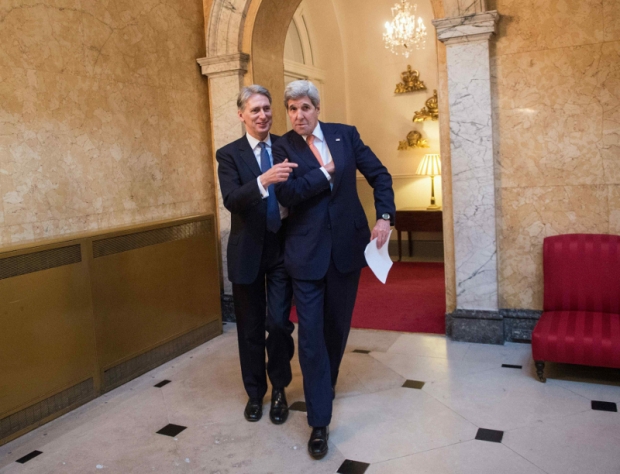 US Secretary of State John Kerry and Britain's Foreign Secretary Philip Hammond arrive to address the media at the donors Conference for Syria in London Britain