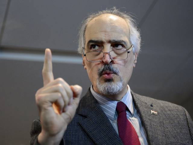 Syrian ambassador to the UN and head of the government delegation Bashar al Jaafari gestures as he holds a press conference during the Syria peace talks in Geneva