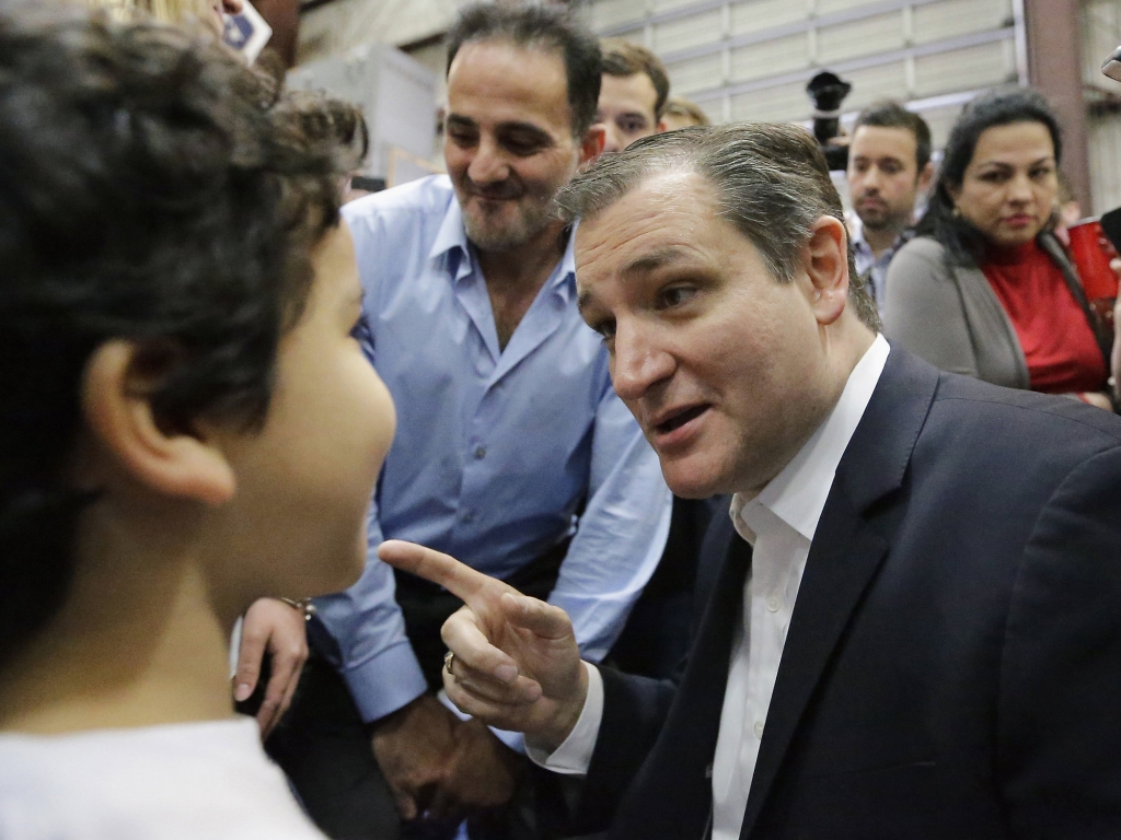 Republican presidential candidate Sen. Ted Cruz R-Texas right talks with Lucas Marmolejos 7 left after speaking at a rally Wednesday Feb. 24 2016 in Houston