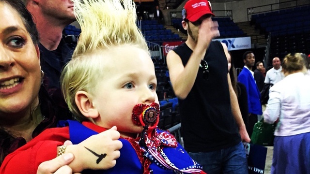 Donald Trump autographs baby at rally