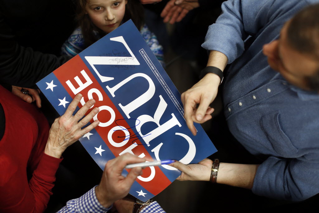 Sen. Ted Cruz autographs a campaign sign at Western Iowa Tech Community College in Sioux City Iowa on Jan. 30 2016