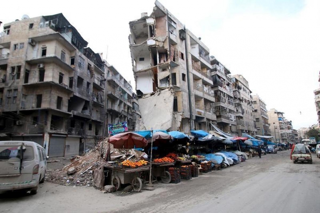 Stalls are seen on a street beside damaged buildings in Aleppo Syria