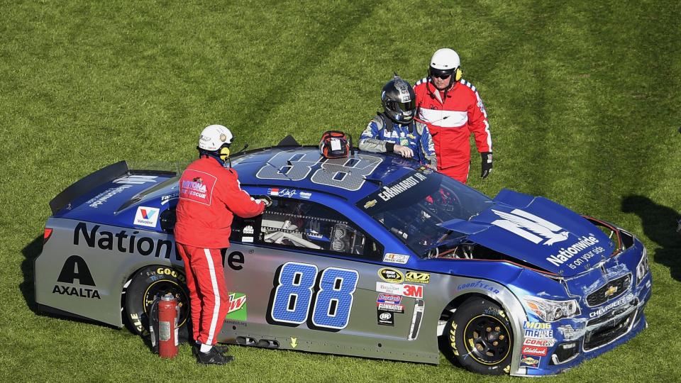 Dale Earnhardt Jr. is helped out of his car after hitting an interior wall as he was losing control of his car coming out of Turn 4 during the NASCAR Daytona 500 Sprint Cup series auto race at Daytona International Speedway Sunday Feb. 21 2016