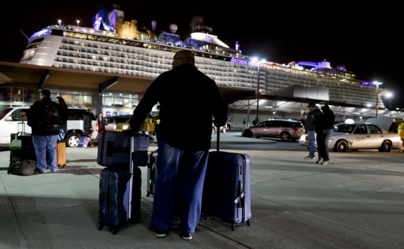 A passenger from the Royal Caribbean cruise ship Anthem of
the Seas waits for transportation after arriving at the Cape Liberty
cruise port in Bayonne N.J. Wednesday. The ship was forced to turn
around after hitting a strong storm at sea