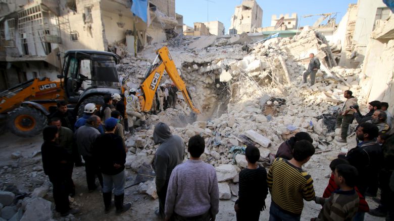 Civil defense members search for survivors after airstrikes by pro Syrian government forces in the rebel held al Qaterji neighbourhood of Aleppo on Monday. MSF claims that a hospital was struck on Tuesday but did not cite the origin of the air strikes. RE