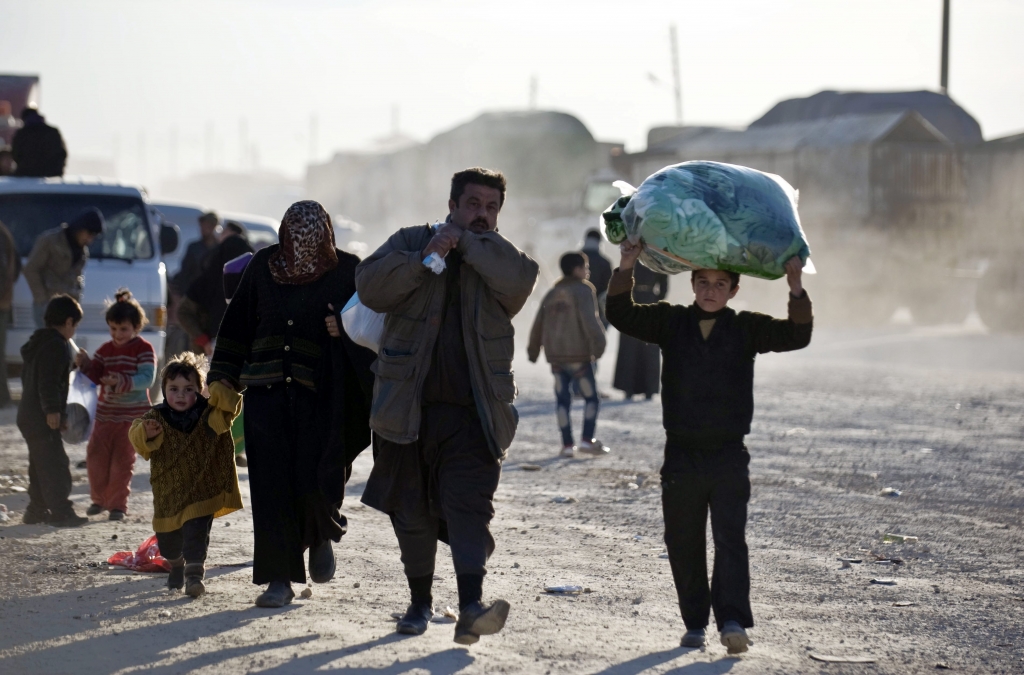 Syrians walk towards the Turkish border at the Bab al Salam border gate Syria Friday Feb. 5 2016