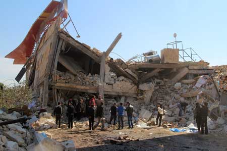 SYRIAN HORROR People gather around the rubble of a hospital supported by Doctors Without Borders near Maaret al-Numan in Syria’s northern province of Idlib on February 15 after the building was hit by suspected Russian air strikes. AFP